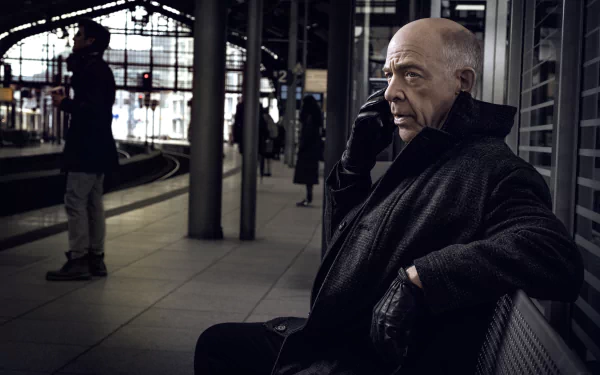 HD desktop wallpaper featuring a scene from Counterpart with a man on a phone at a train station.