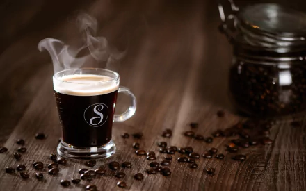 HD desktop wallpaper showing a steaming cup of coffee with scattered coffee beans and a glass jar on a wooden surface.
