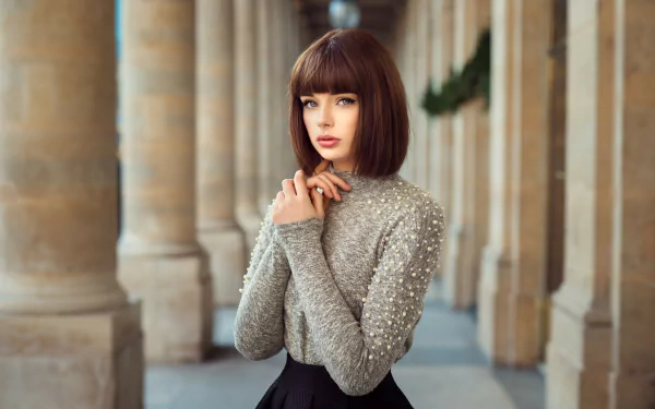 HD desktop wallpaper featuring Marie Grippon, a brunette model with short hair, blue eyes, and lipstick, captured with a shallow depth of field.