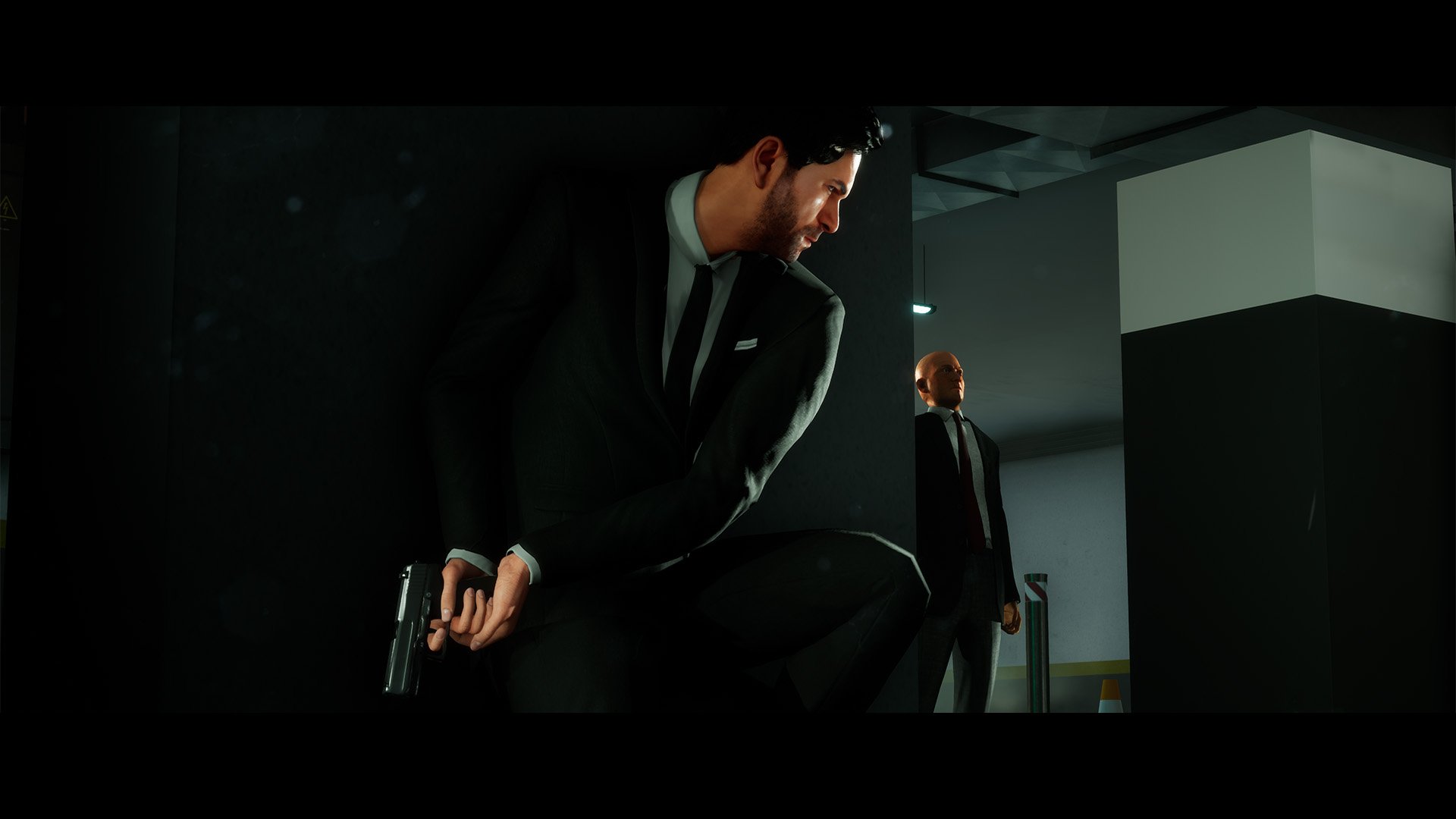HD Past Cure game wallpaper featuring a crouched man with a gun in a sleek suit, ready for action in a modern, dimly lit environment.