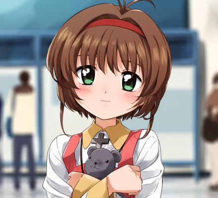 Sakura Kinomoto (Cardcaptor Sakura) anime HD PC desktop wallpaper: close-up of her smiling with green eyes, short brown hair, red hairband, and a small gray stuffed bear against a blurred background.