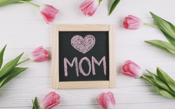4K Ultra HD desktop wallpaper featuring pink tulips arranged around a chalkboard with a heart and MOM written, celebrating Mother's Day and holiday flowers.