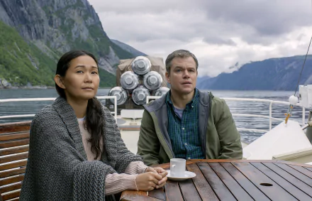 HD desktop wallpaper featuring Matt Damon and Hong Chau in Downsizing, with a scenic mountainous backdrop.