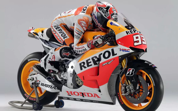 HD PC desktop wallpaper and background of a Repsol Honda MotoGP sports rider in full leathers crouched on a race bike.
