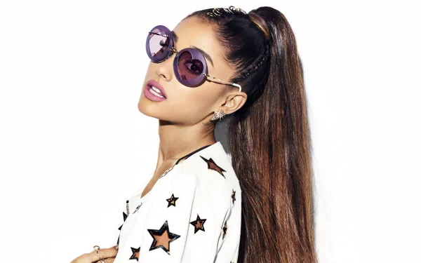 HD desktop wallpaper of American actress and singer Ariana Grande, a brunette Latina celebrity wearing round sunglasses and a star-patterned outfit.