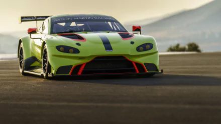 Front view of neon green Aston Martin Vantage GTE race car on track at sunset, high-detail 5K Ultra HD PC desktop wallpaper background.