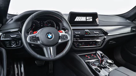 BMW M5 MotoGP Safety Car interior — 5K Ultra HD PC desktop wallpaper showing the M5 cockpit, steering wheel, dashboard and center console.