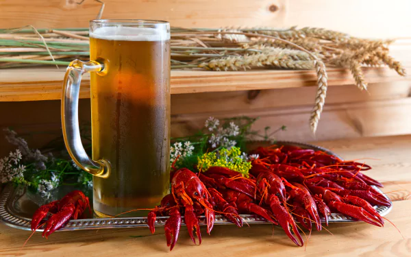 A 4K Ultra HD wallpaper featuring a glass of beer alongside a spread of bright red crustaceans and herbs on a wooden surface, evoking seafood and drink themes.
