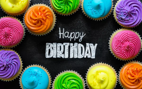 Vibrant colorful cupcakes surround a chalkboard with Happy Birthday text, creating a festive 4K Ultra HD holiday birthday wallpaper and background.