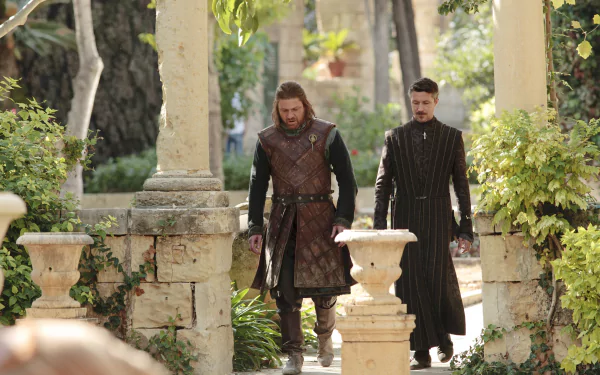 Two men in medieval costume walk through a sunlit stone garden, cinematic scene from a fantasy TV series, 4K Ultra HD PC desktop wallpaper.