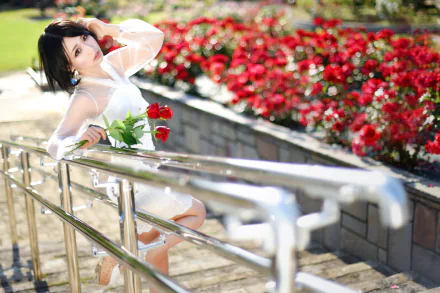 Asian brunette model with brown eyes poses holding a red rose beside a vibrant rose garden, captured with bokeh and depth of field in an HD desktop wallpaper.