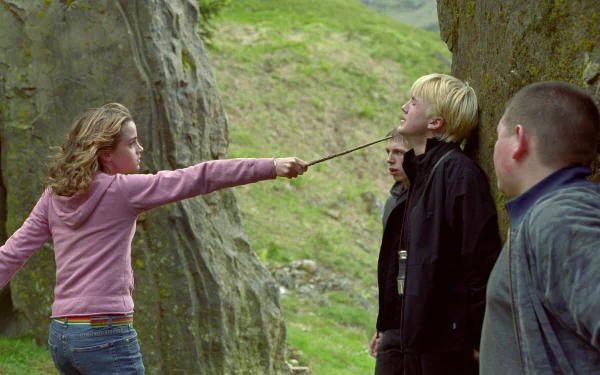 HD desktop wallpaper from the movie Harry Potter and the Prisoner of Azkaban, featuring Hermione Granger pointing her wand at Draco Malfoy with others watching nearby.