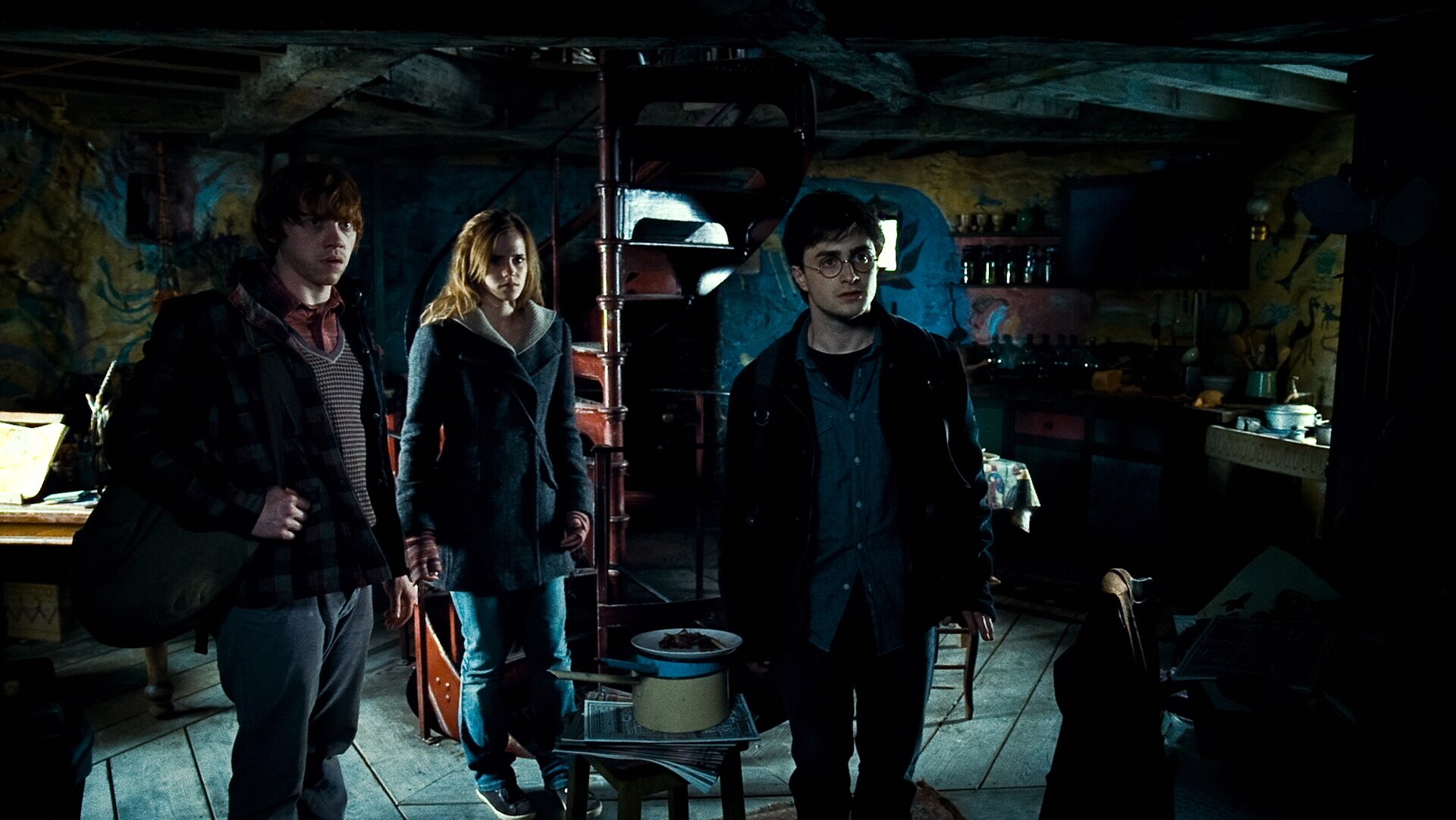 Harry Potter, Hermione Granger, and Ron Weasley stand together in a dimly lit room from the movie Harry Potter and the Deathly Hallows: Part 1, HD PC desktop wallpaper.