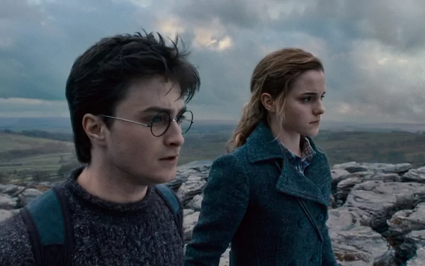 HD desktop wallpaper featuring Harry Potter and Hermione Granger from the movie Harry Potter and the Deathly Hallows: Part 1, set against a dramatic outdoor landscape.