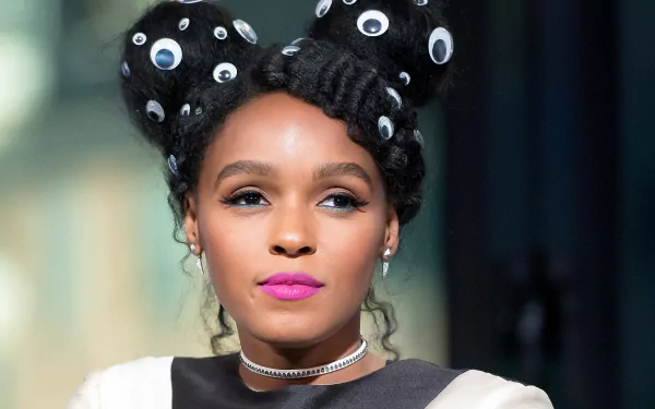 HD desktop wallpaper featuring a portrait of a woman with creative hairdo, adorned with eye-catching accessories, exuding confidence and style.