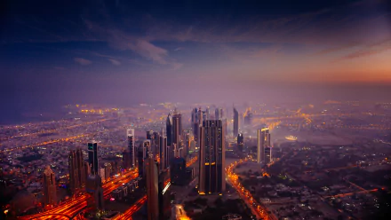 Nighttime cityscape of Dubai featuring the illuminated Burj Khalifa skyscraper against a dark sky, captured in 4K Ultra HD detail.
