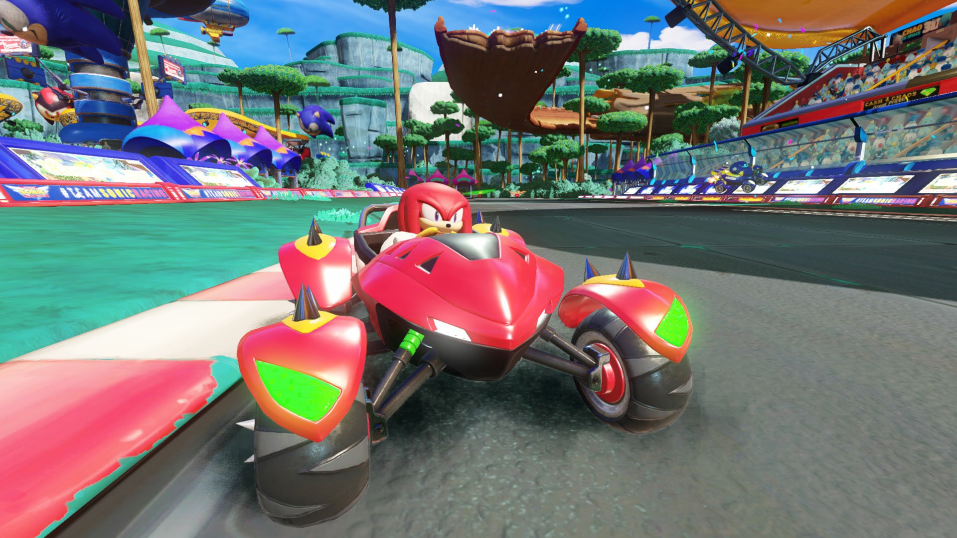 HD wallpaper featuring a scene from Team Sonic Racing with a vibrant race track and Knuckles in his red race car.