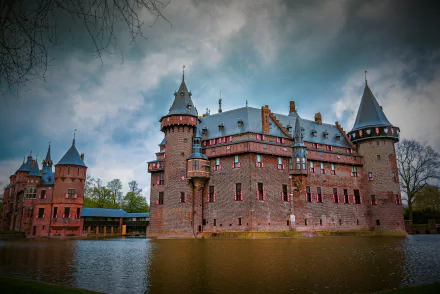 4K Ultra HD PC desktop wallpaper and background: man-made castle with turrets and moat, dramatic historic architecture reflected in calm water.
