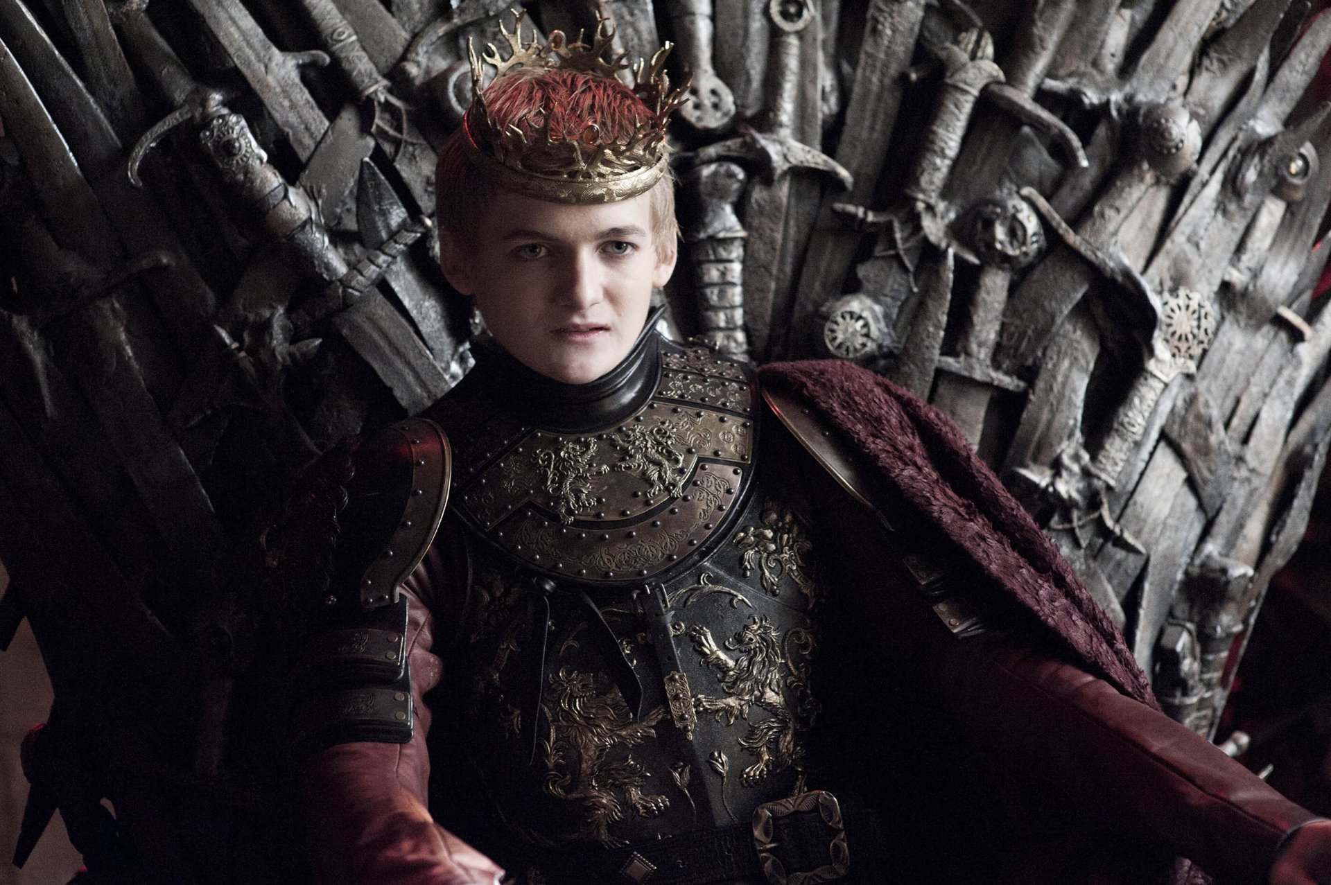 Joffrey Baratheon in ornate crown and armor seated on the Iron Throne — Game of Thrones HD PC desktop wallpaper.