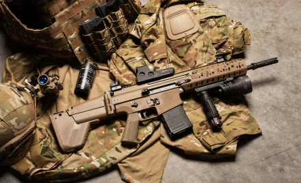 4K Ultra HD desktop wallpaper featuring a man-made FN SCAR rifle displayed on tactical military gear.