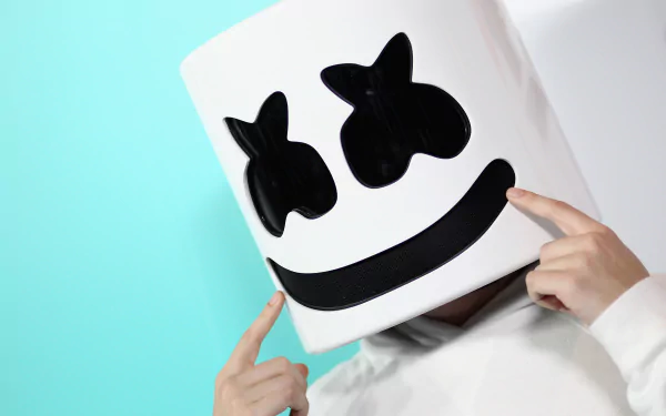 HD desktop wallpaper of Marshmello, the famous DJ, wearing his signature marshmallow helmet against a blue and white background.