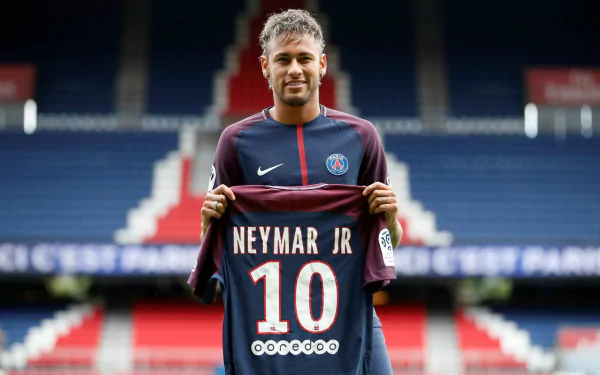HD wallpaper of Neymar holding his number 10 PSG jersey at the stadium.