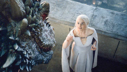 Daenerys Targaryen, played by Emilia Clarke, interacts with her dragon Drogon in a detailed scene from the TV show Game of Thrones, captured in an HD desktop wallpaper.