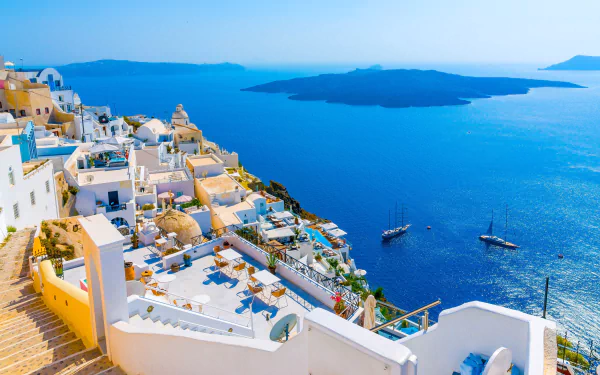 A stunning view of Santorini overlooking the Ionian Sea, showcasing vibrant buildings and the horizon kissed by shimmering waters, captured in vibrant 4K Ultra HD.