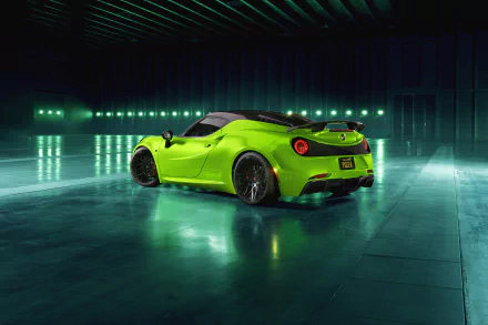 Vibrant green Alfa Romeo 4C supercar on a reflective floor in a dim industrial garage — 4K Ultra HD desktop wallpaper showcasing the sleek performance vehicle