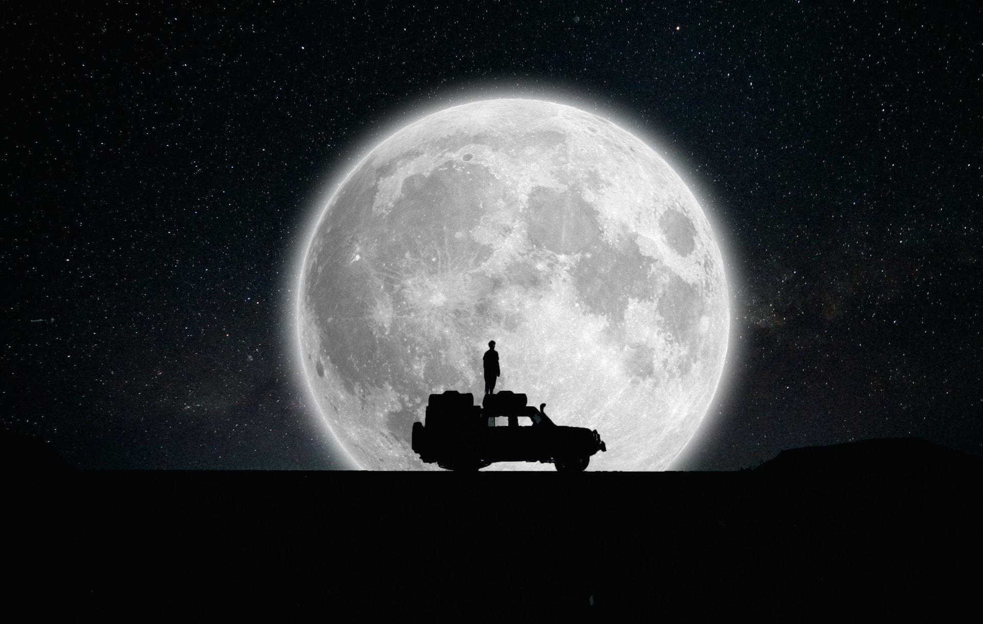 Car silhouette and lone figure beneath a massive moon in a sci-fi night sky — 2K Quad HD PC desktop wallpaper/background.