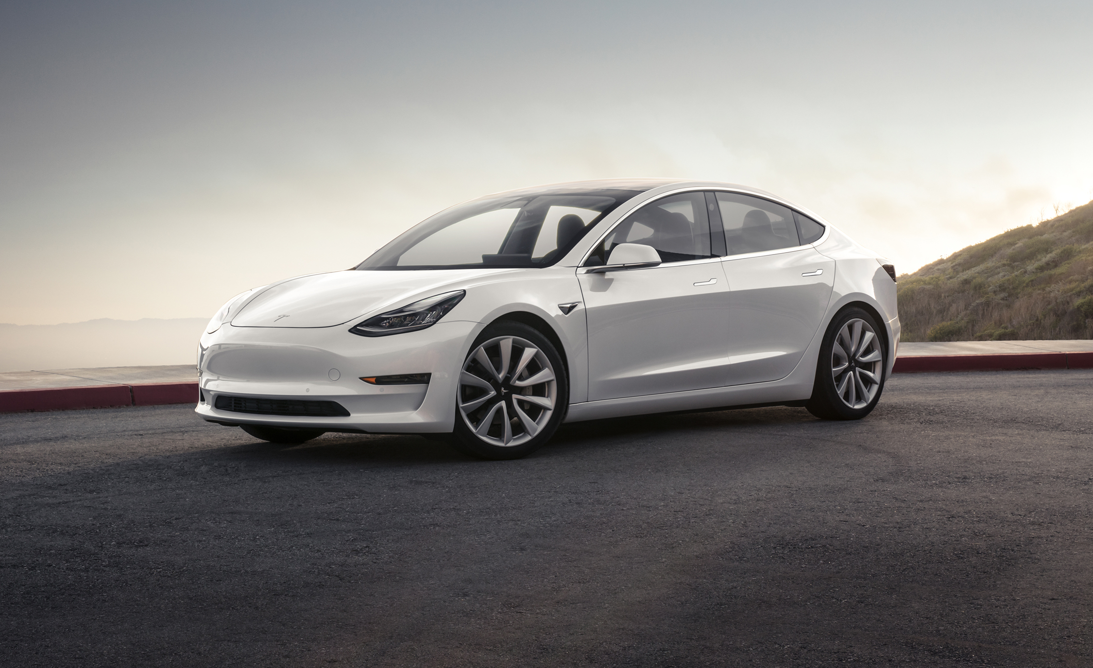 White Tesla Model 3 by Tesla Motors, positioned prominently as a high-definition desktop wallpaper and background.