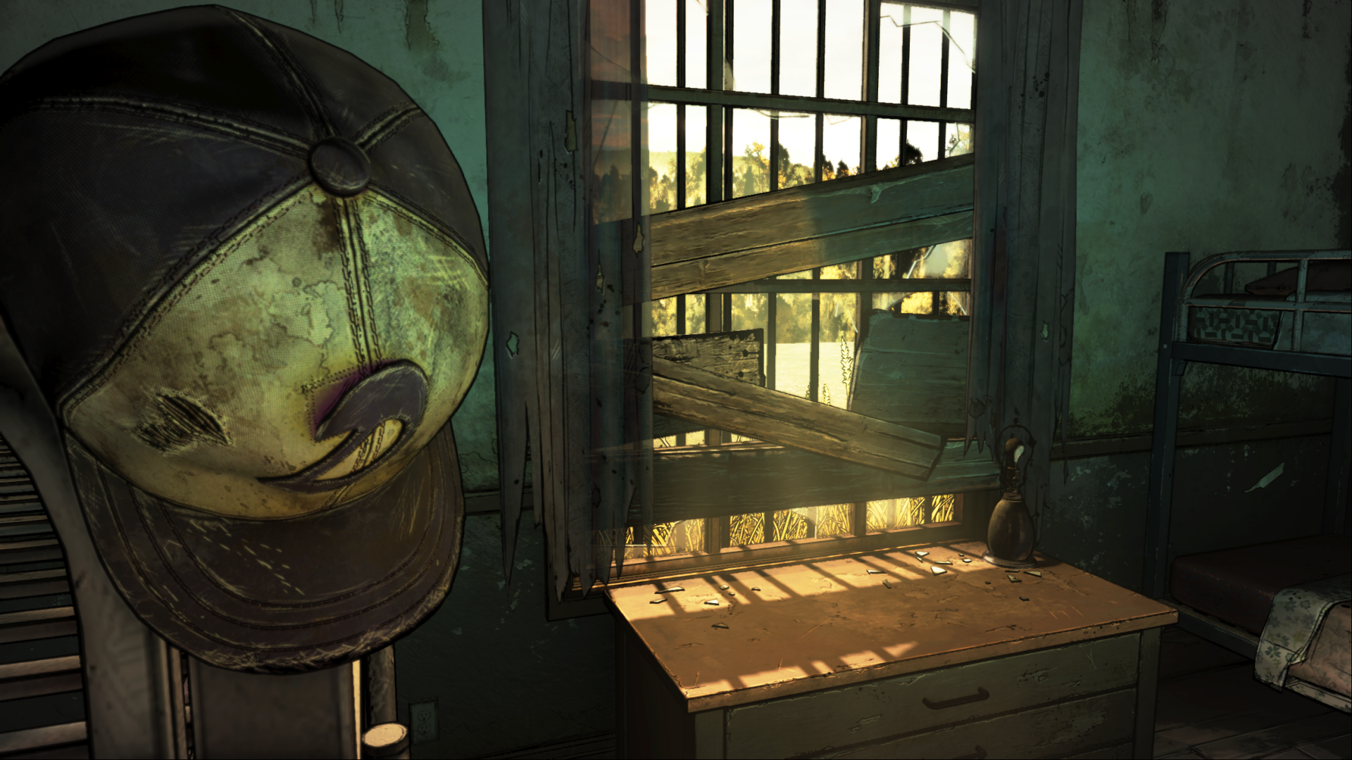 HD PC desktop wallpaper from the video game The Walking Dead: The Final Season — a worn baseball cap with a faded smiley hangs beside a sunlit, boarded-up window above a dusty desk.