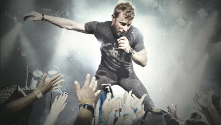 HD desktop wallpaper featuring a dynamic concert scene with a performer engaging with the audience, suitable as a background.
