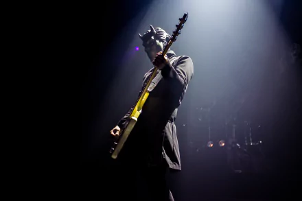 HD desktop wallpaper featuring a member of Ghost B.C. playing guitar on stage under a spotlight.
