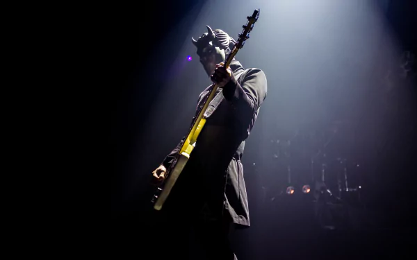 HD desktop wallpaper featuring a member of Ghost B.C. playing guitar on stage under a spotlight.