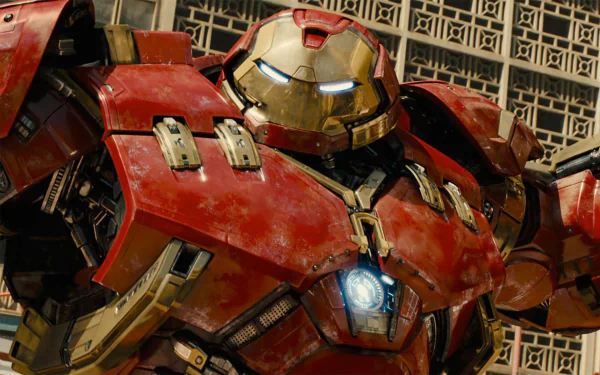 Hulkbuster armor close-up from the movie Avengers: Age of Ultron, presented as an HD PC Desktop Wallpaper and Background with red-gold plating and a glowing arc reactor.
