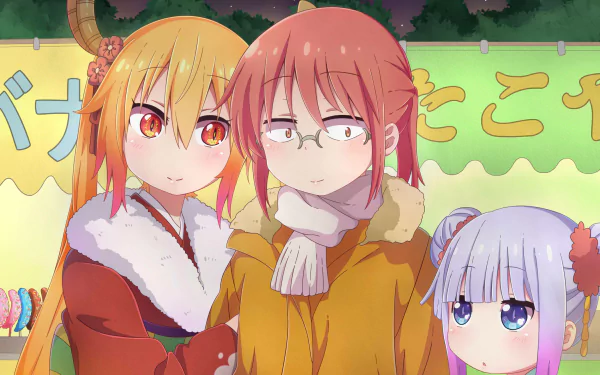 HD PC wallpaper of Miss Kobayashi's Dragon Maid: Tohru, Kobayashi and Kanna bundled in winter coats at a colorful festival stall, sharing warm expressions under the evening sky.