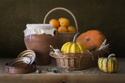 HD PC desktop wallpaper showing a rustic arrangement of pumpkins, a clay pot covered with cloth, baskets, and ceramic bowls against a dark background.
