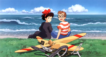 HD PC desktop wallpaper featuring anime characters Kiki and Tombo from Kiki's Delivery Service sitting by the ocean with a bicycle and colorful glider.
