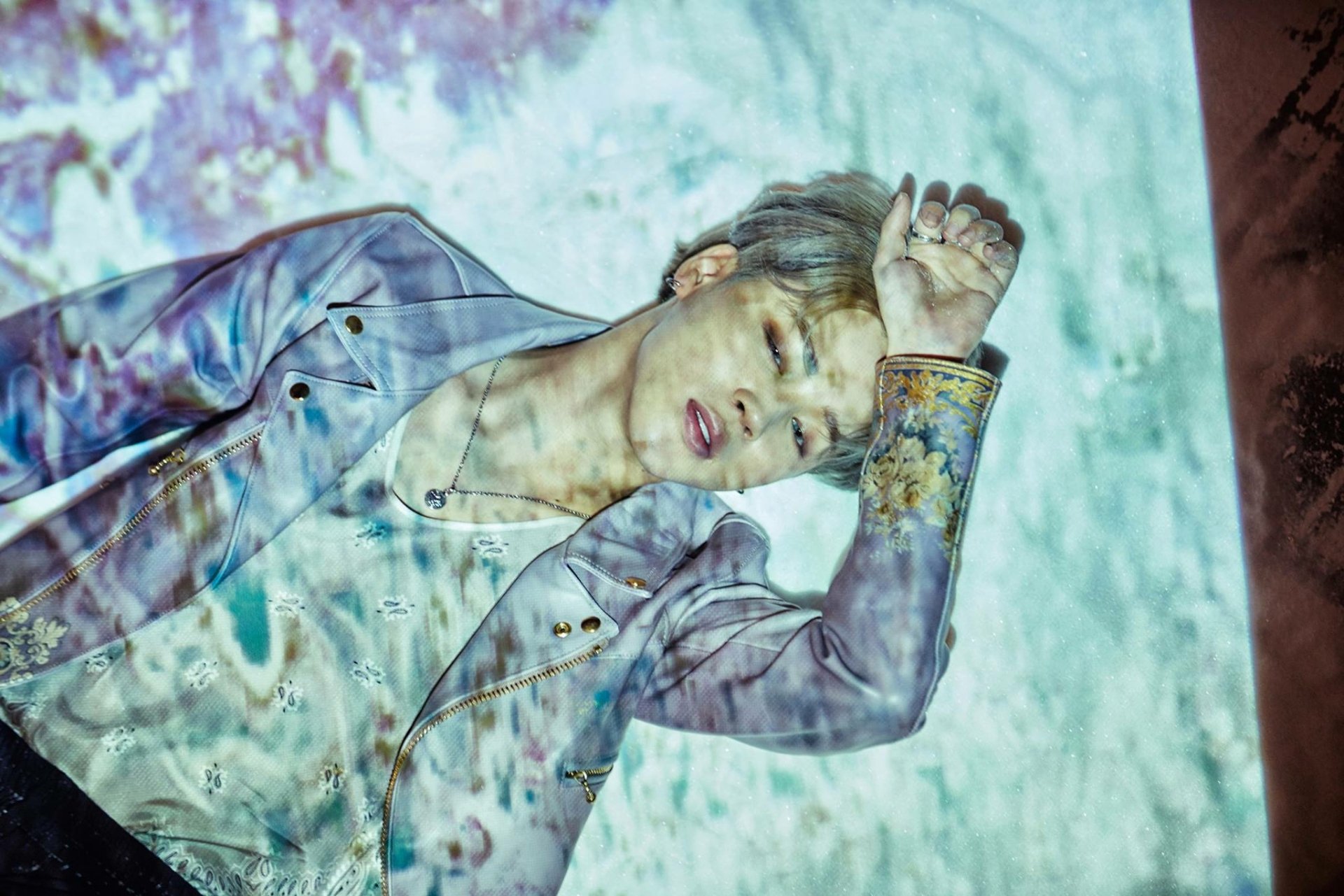HD desktop wallpaper featuring Jimin from BTS in a dreamy, artistic setting with a projected texture overlay, embodying music and creativity.