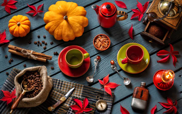 A vibrant still life featuring coffee beans, cinnamon sticks, a grinder, pumpkin, lantern, compass, spoon, knife, and colorful cups arranged on a dark wooden surface in 4K Ultra HD.
