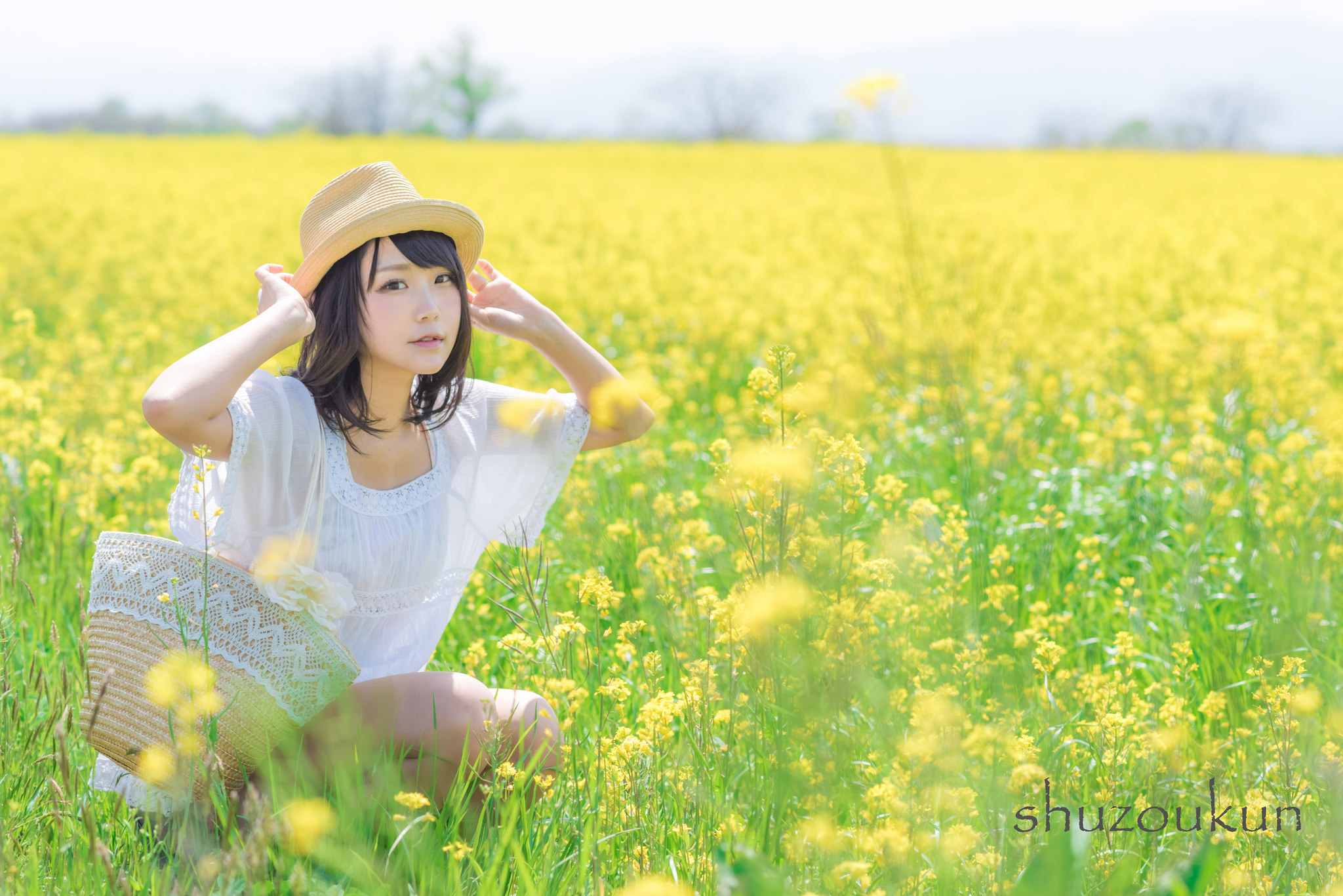 Woman sitting in a field of flowers with a cute basket and hat by shuzoukun