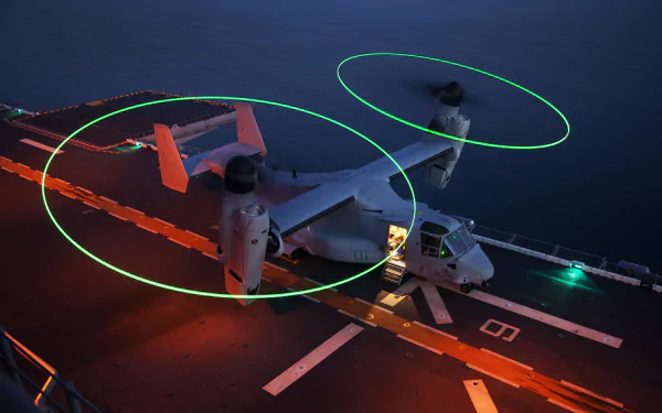 Bell Boeing V-22 Osprey transport aircraft and helicopter on a ship deck at night, captured in 4K Ultra HD for a military-themed desktop wallpaper.