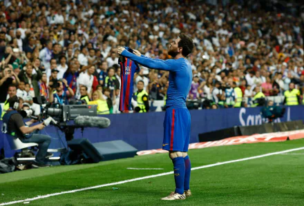 Lionel Messi celebrates passionately with a jersey in hand, surrounded by a vibrant crowd, capturing the spirit of sports in this HD desktop wallpaper.