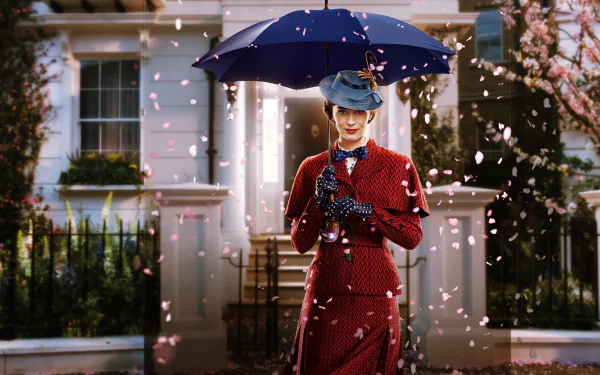 Emily Blunt as Mary Poppins in a red outfit holding a blue umbrella, standing in front of a house with petals falling around her, captured in 8K Ultra HD movie wallpaper.