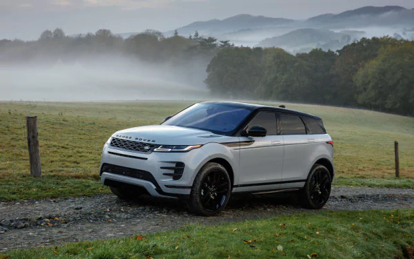 Silver Range Rover Evoque SUV vehicle parked on a gravel lane with misty hills in the background — 4K Ultra HD PC desktop wallpaper and background.