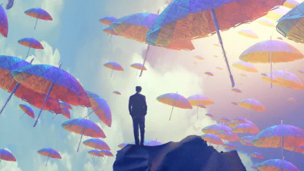 Artistic HD wallpaper featuring a silhouette of a person standing on a rock amidst a sky filled with colorful floating umbrellas.