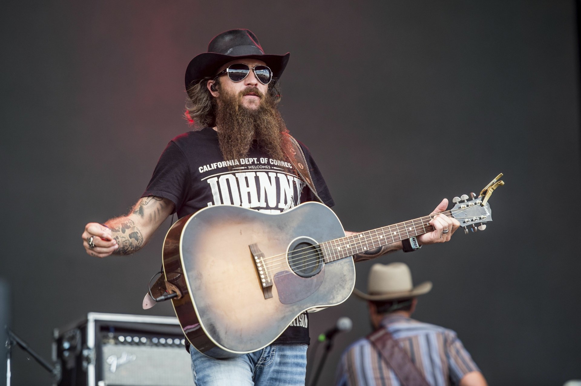 Cody Jinks performing with a guitar, in HD desktop wallpaper and background.