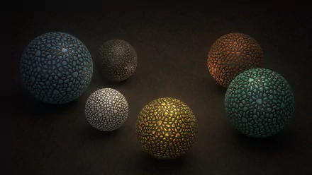 Abstract composition of six textured mosaic balls in warm and cool tones on a dark surface — 2K Quad HD PC desktop wallpaper and background.