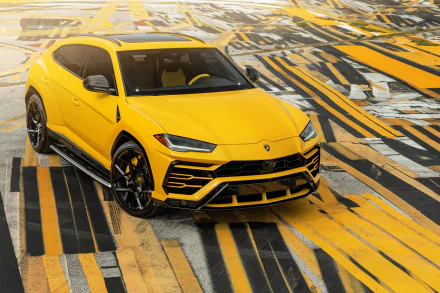 Bright yellow Lamborghini Urus SUV on a stylized yellow-and-black patterned surface, 8K Ultra HD PC desktop wallpaper.